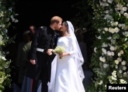 Prince Harry and Meghan, the Duchess of Sussex, kiss as they leave St George's Chapel at Windsor Castle after their wedding, May 19, 2018.