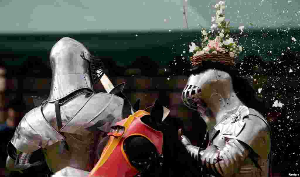 Australian knight Philip Leitch (R) has a floral basket on his helmet smashed by an opponent at the St. Ives Medieval Fair in Sydney, one of the largest of its kind in Australia.