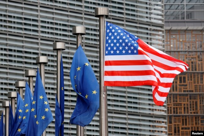 FILE - U.S. and European Union flags are pictured at European Commission headquarters in Brussels, Belgium