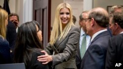 In this Nov. 14, 2018, photo, Ivanka Trump, the daughter of President Donald Trump, center, greets guests after President Donald Trump spoke about prison reform in the Roosevelt Room of the White House in Washington.