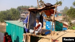 FILE PHOTO: Amir Ali, 75, plays a violin in front of his house in Kutuapalong Rohigya refugee camp in Cox's Bazar, Bangladesh, Feb. 8, 2019.