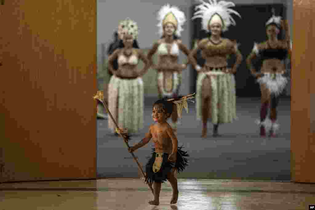 Indigenous people from Rapa Nui, also known as Easter Island, wait for a ceremony to start at the National Museum of Natural History to mark the return of a Moai Tau del Ivi Tupuna statue in Santiago, Chile, Feb. 21, 2022.