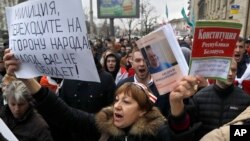 People shout slogans at a rally in Minsk, Belarus, March 15, 2017. The banner on the left calls on police to join the demonstrators.
