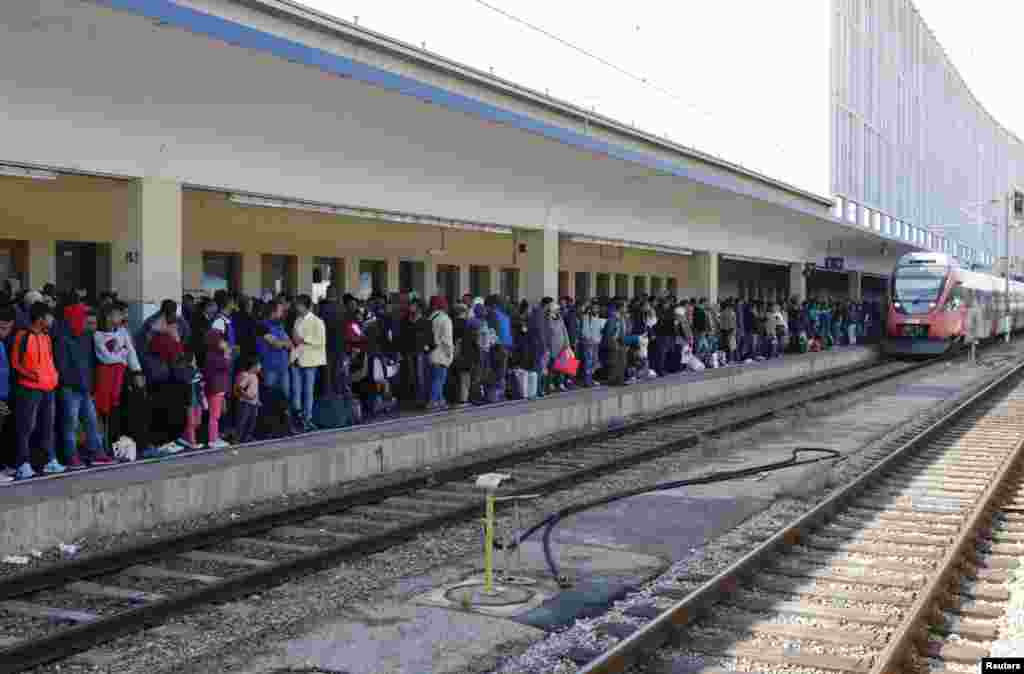 Migrants wait for trains at the Wien Westbahnhof in Vienna, Austria. A police spokesman said a big increase in the flow of migrants will put extra pressure on authorities trying to arrange onward transport to Germany.