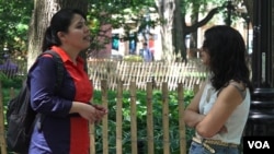 Arely Cordova (left), from Mexico, speaks to a friend on NYU Campus. Cordova says that when she came to the U.S., she realized the struggles that many minorities face in the labor market. (R. Taylor/VOA)