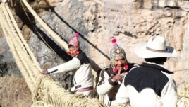 Members of the Huinchiri community rebuild an Incan hanging bridge, known as the Qeswachaka bridge, using traditional weaving techniques in Canas, Peru, June 13, 2021.