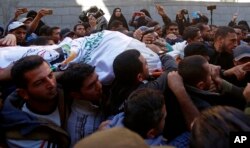 Los dolientes enterraron el lunes a siete milicianos palestinos que murieron en una invasión israelí.