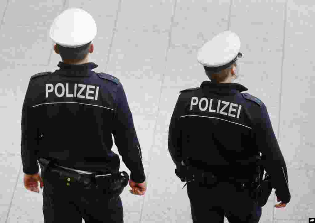 German police officers patrol the airport terminal in Frankfurt, Germany, Jan. 19, 2015.