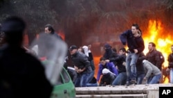 Opposition protesters throw stones at police after a pro-opposition rally in Tirana, Albania, 21 Jan 2011