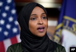 FILE - Rep. Ilhan Omar, D-Minn., speaks to reporters in the wake of anti-Islamic comments made by Rep. Lauren Boebert, R-Colo., who likened Omar to a bomb-carrying terrorist, during a news conference at the Capitol in Washington, Nov. 30, 2021.