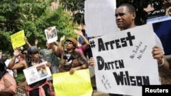Protestors at the St. Louis County Justice Center call for the arrest of Police Officer Darren Wilson in Clayton, Missouri, Aug. 20, 2014.