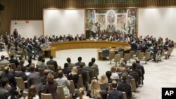 In this photo provided by the United Nations, the United Nations Security Council votes on a resolution that threatens Syria with new sanctions in New York, July 19, 2012.