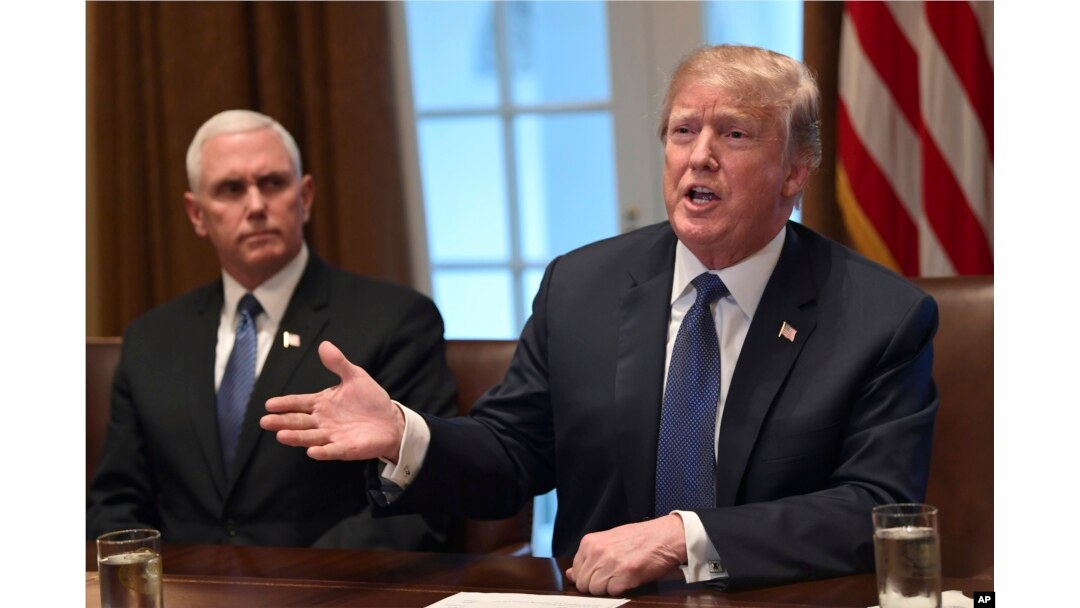 President Donald Trump, right, sitting next to Vice President Mike Pence, left, speaks in the Cabinet Room of the White House in Washington, April 9, 2018, at the start of a meeting with military leaders.