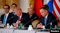 U.S. President Donald Trump talks to Polish President Andrzej Duda as U.S. Secretary of the Treasury Steven Mnuchin, White House Senior Advisor Jared Kushner and U.S. Secretary of Commerce Wilbur Ross listen during the Three Seas Initiative Summit in Warsaw, Poland, July 6, 2017.