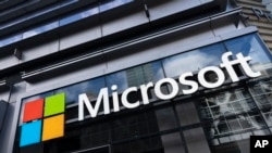 This May 6, 2021 photo shows a sign for Microsoft offices in New York. (AP Photo/Mark Lennihan)