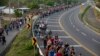 Migrants Push Past Gate, Police to Enter Mexico