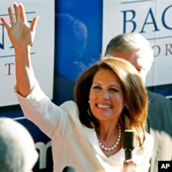 Republican presidential candidate Rep. Michele Bachmann, R-Minn., waves to supporters outside her campaign bus after being named the winner of the Iowa Republican Party's Straw Poll, Saturday, Aug. 13, 2011, in Ames, Iowa.