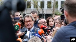 FILE - Artur Mas, a former President of Catalonia, talks to journalists outside the national court in Madrid, Spain, Nov. 2, 2017.