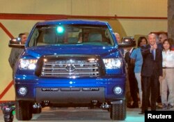 Katsuaki Watanabe, who at the time was president of Toyota Motor Corp., signals his pleasure as the company rolls out its first 2007 Tundra trucks made at the plant in San Antonio, Texas, Nov. 17, 2006.