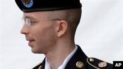 Army Pfc. Bradley Manning is escorted out of a courthouse after receiving a verdict in his court-martial, in Fort Meade, Maryland, July 2013.