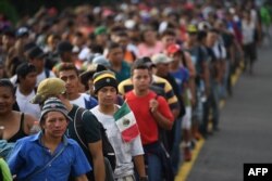 Honduran migrants take part in a caravan heading to the US on the road linking Ciudad Hidalgo and Tapachula, Chiapas state, Mexico, Oct. 21, 2018.