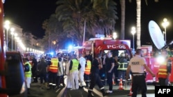 Police officers, firefighters and rescue workers are seen at the site of an attack on July 15, 2016, after a truck drove into a crowd watching a fireworks display in the French Riviera town of Nice.
