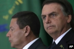 Brazil's President Jair Bolsonaro and his Vice President Hamilton Mourao attend a ceremony during which the country's government bank presidents are presented at Planalto presidential palace in Brasilia, Brazil, Jan. 7, 2019.