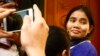 Yorm Bopha, right, a Boeung Kak lake villager, enters a court room for her hearing at the Supreme Court in Phnom Penh, Cambodia, Friday, Nov. 22, 2013.