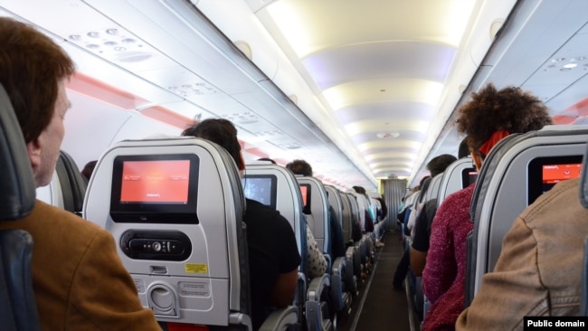 Passengers relax during a flight.