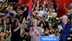 Democratic presidential candidate Hillary Clinton, center, celebrates on stage with her family, from left, Chelsea Clinton, Mark Mezvinsky, and husband former president Bill Clinton, right, at her victory party after winning the New York state primary.