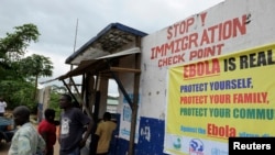 Liberian soldiers stop people at an Ebola checkpoint in Bomi County, Aug. 11, 2014.