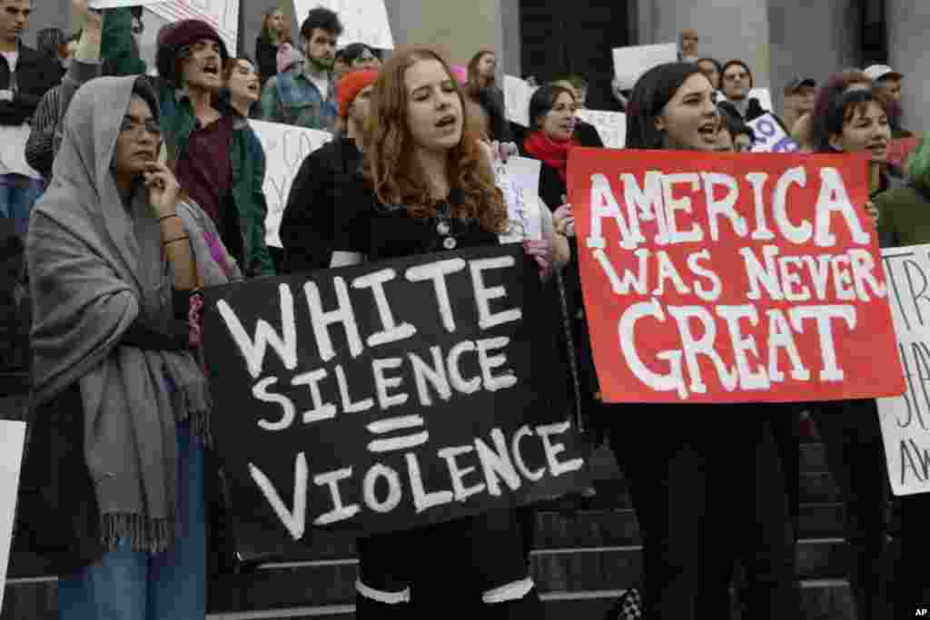 Protesters in opposition of President-elect Donald Trump gather on the steps of the state Capitol in Olympia, Washington, Nov. 11, 2016. More than 200 people chanted and individually spoke against the outcome of the election.