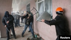 Pro-Russian men storm a police station in the eastern Ukrainian town of Horlivka, April 14, 2014. 