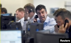 Brokers react on a trading floor at BGC, in the Canary Wharf financial district of London, June 27, 2016.