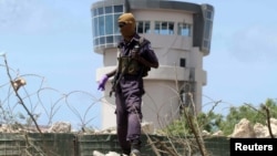 A policeman stands guard near the air-control tower of a airport following a suicide bombing near the African Union's main peacekeeping base in Mogadishu, Somalia, July 26, 2016. 