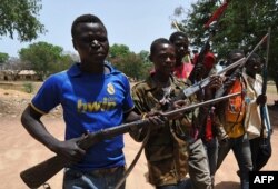 FILE - A picture taken on March 6, 2014 shows members of the Chritisian militant group Revolution of Justice (RJ) arriving in the village Nanga Boguila between Bossangoa and Bozoum.