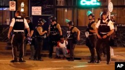 Police detain a man after a earlier peaceful protest in response to a not guilty verdict in the trial of former St. Louis police officer Jason Stockley turned violent, Sept. 17, 2017, in St. Louis. 