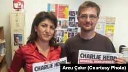FILE - Stephane Charbonnier, right, editor-in-chief of 'Charlie Hebdo,' was interviewed in 2012 by VOA's Arzu Çakır.