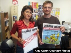 Stephane Charbonnier, right, editor-in-chief of the French publication Charlie Hebdo, was interviewed in 2012 by VOA's Arzu Çakır. Charbonnier was killed in an attack that left at least 12 people dead, in Paris, France, Jan. 7, 2015.