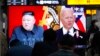 FILE - Commuters watch a TV showing file images of North Korean leader Kim Jong Un and U.S. President Joe Biden during a news program at the Suseo Railway Station in Seoul, South Korea, March 26, 2021.