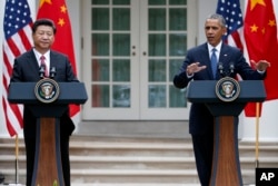 FILE - President Barack Obama gestures during a joint news conference with Chinese President Xi Jinping, Sept. 25, 2015, in the Rose Garden of the White House in Washington.