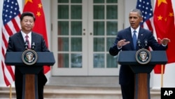 President Barack Obama gestures during a joint news conference with Chinese President Xi Jinping, Sept. 25, 2015, in the Rose Garden of the White House in Washington.