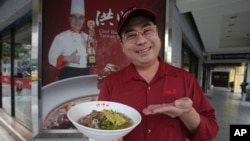 Chef Hung shows pineapple beef noodle outside of his restaurant in Taipei, Taiwan, Wednesday, March 10, 2021. (AP Photo/Chiang Ying-ying)