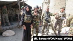 Afghan National Army troops accompany a VOA team, including reporter Ayesha Tanzeem, to a police checkpoint in Achin, a district in eastern Afghanistan. (R. Sarwan/VOA News)
