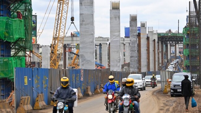 FILE - Motorists drive next to the ongoing construction site of the Nairobi Expressway, undertaken by the China Road and Bridge Corp., in Nairobi, Kenya, July 12, 2021. As Africa’s biggest investor, China has been responsible for major infrastructure projects in Kenya.