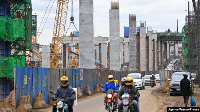 FILE - Motorists drive on Mombasa road, next to the ongoing construction site of the Nairobi Expressway, undertaken by the Chinese contractor China Road and Bridge Corporation, in Nairobi, Kenya, July 12, 2021.