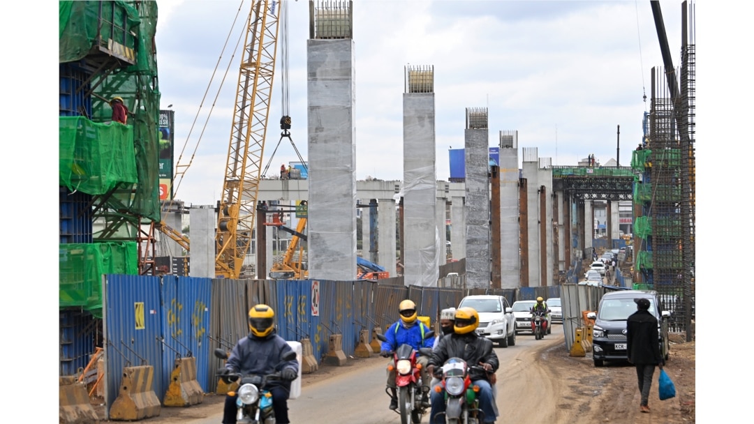 FILE - Motorists drive on Mombasa road, next to the ongoing construction site of the Nairobi Expressway, undertaken by the Chinese contractor China Road and Bridge Corporation (CRBC), in Nairobi, Kenya, July 12, 2021.