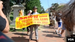 Protesters highlight what they call Vietnam's poor human rights record during a rally near the White House in Washington, D.C, July 25, 2013.