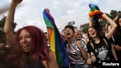 FILE - Revellers cheer during the annual Sofia Pride parade in Sofia, Bulgaria, June 9, 2018.