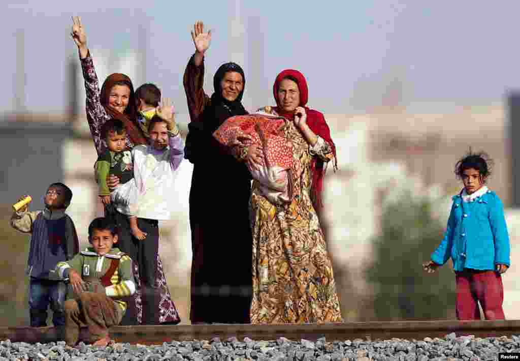 Syrian women from Ras al-Ain are pictured from the Turkish border town of Ceylanpinar, Sanliurfa province, November 11, 2012.